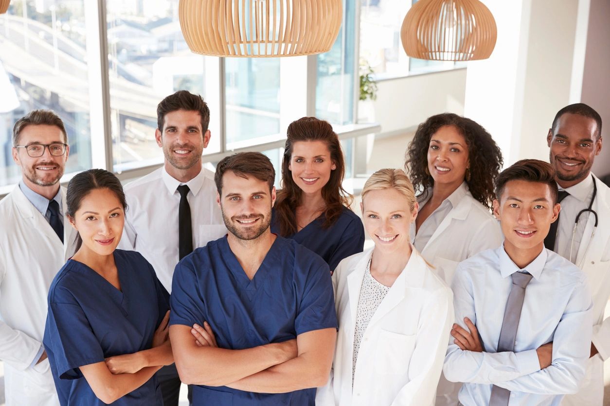 Diverse medical team posing confidently in a bright clinic.